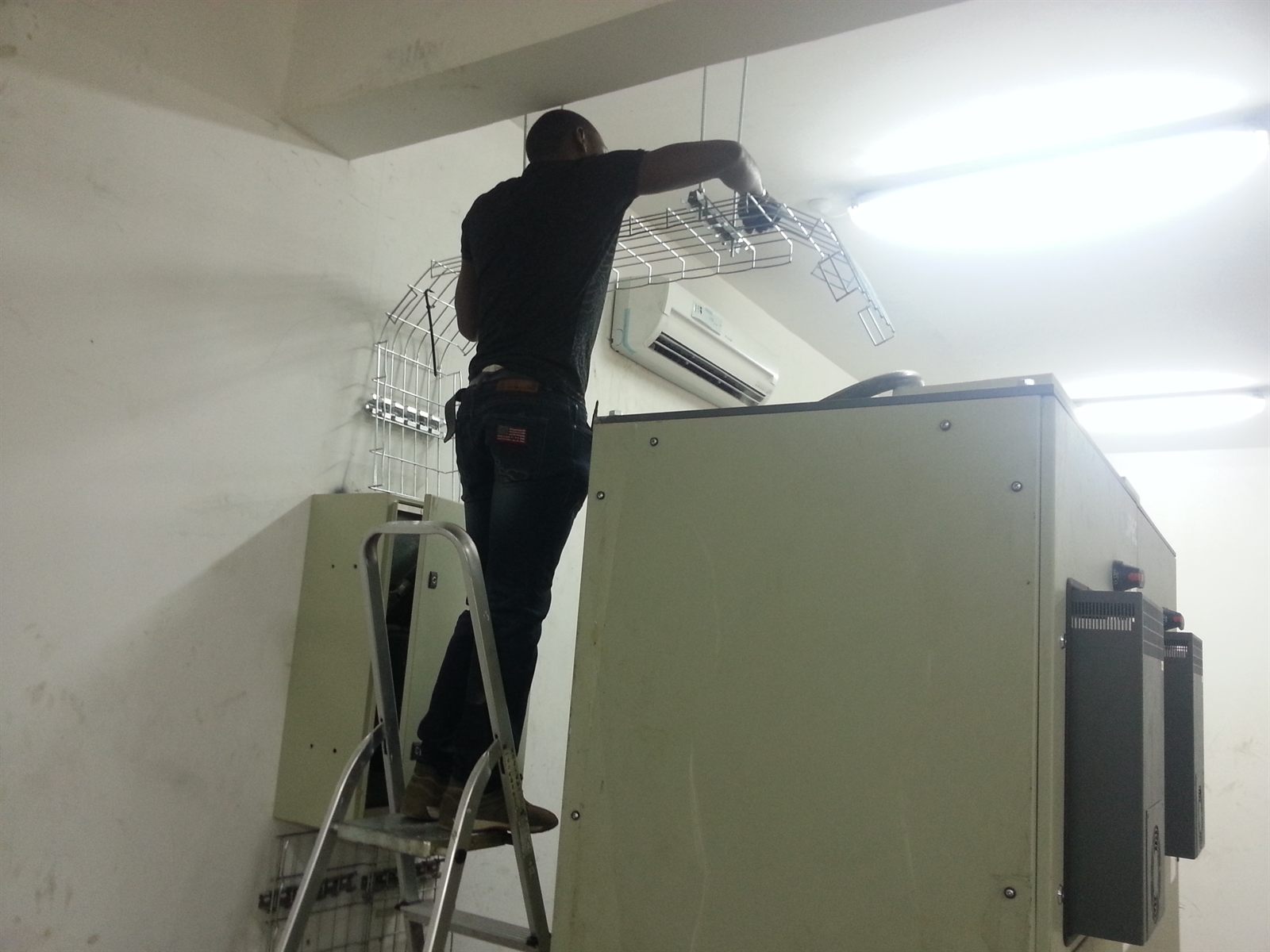 Transez field engineer working inside a facility equipment room